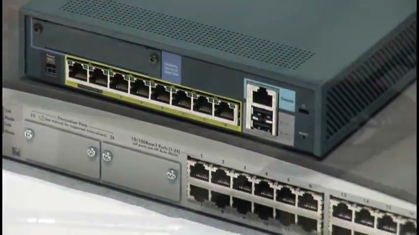 Close-up of stacked network switches showing banks of RJ45 ports and uplink modules.