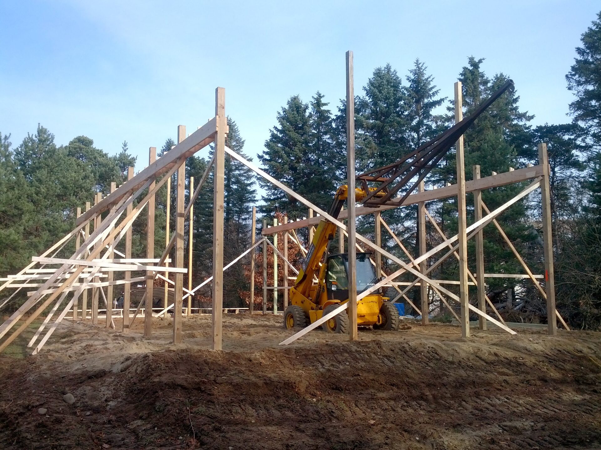 Pole barn framing going up with telehandler